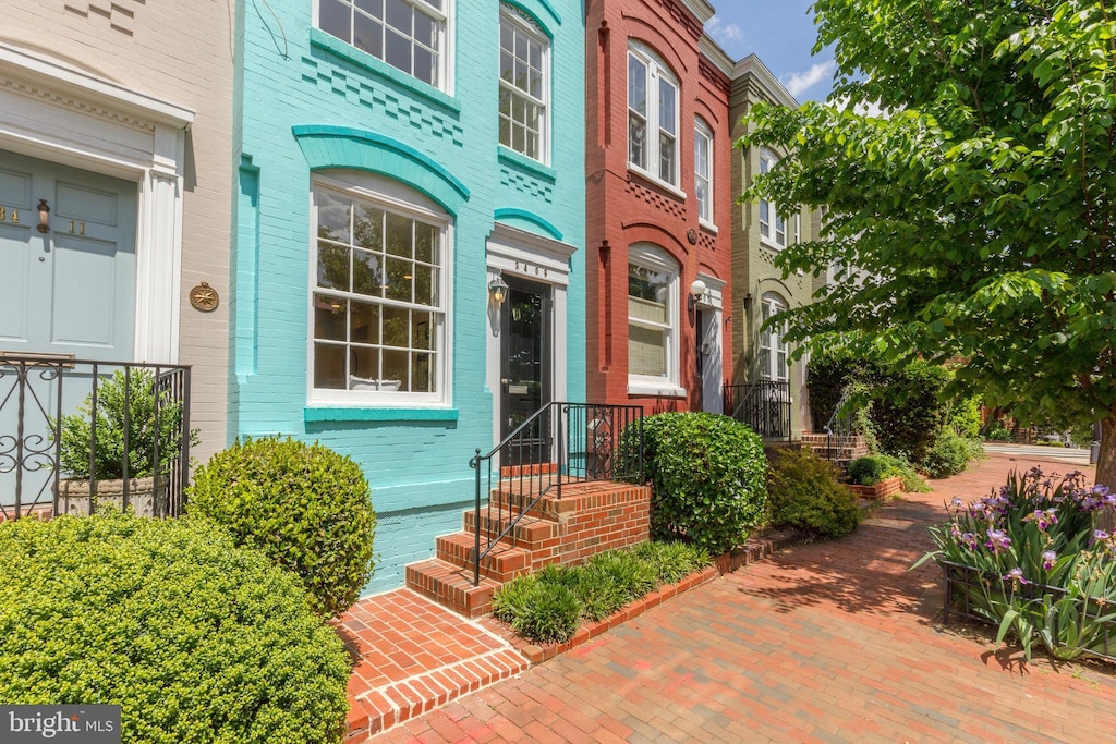 property entrance featuring brick siding