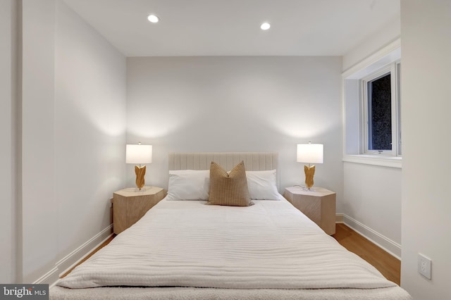 bedroom with baseboards, recessed lighting, and wood finished floors