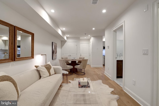 living room featuring visible vents, recessed lighting, light wood-style flooring, and baseboards