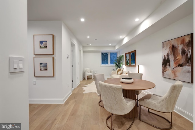 dining room featuring baseboards, recessed lighting, and light wood-style flooring