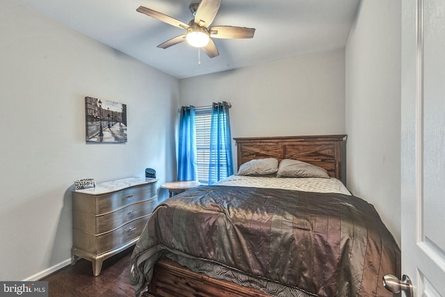 bedroom featuring wood finished floors, baseboards, and a ceiling fan