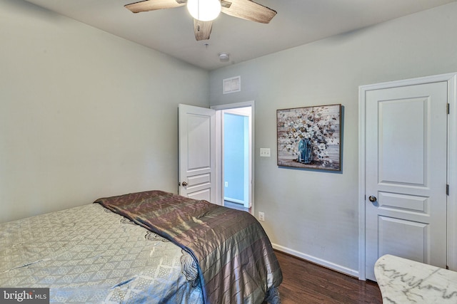 bedroom with dark wood-type flooring, baseboards, and a ceiling fan