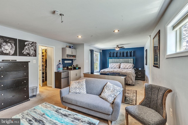 bedroom with light carpet, freestanding refrigerator, recessed lighting, and ceiling fan
