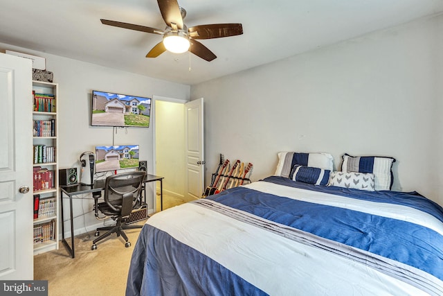 bedroom featuring light colored carpet, a desk, and ceiling fan