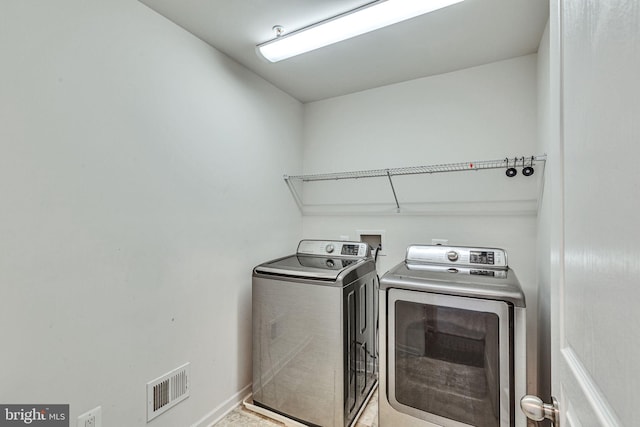 laundry area featuring washing machine and clothes dryer