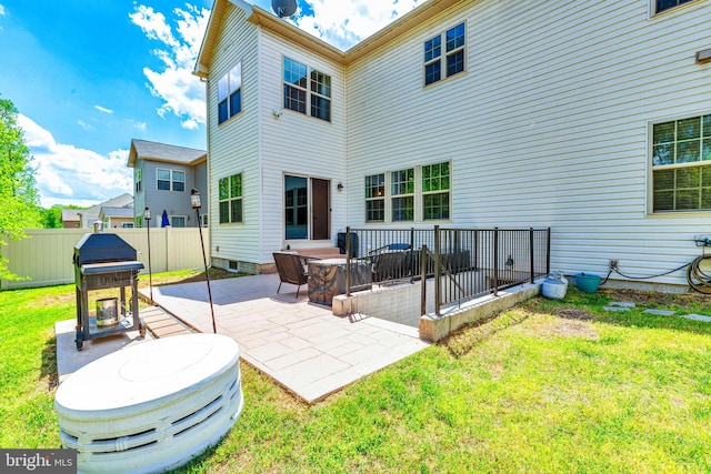 back of house featuring a yard, a patio area, and fence