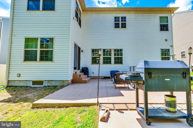 rear view of property with a patio and entry steps