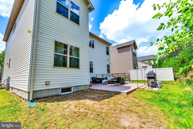 back of house with a patio and an outdoor living space
