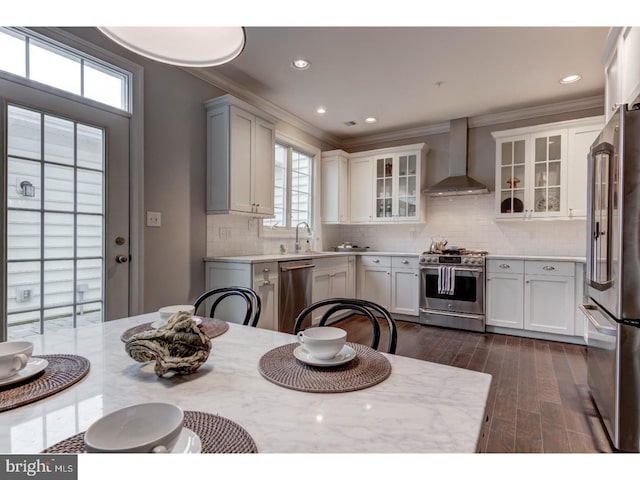602 D St, Kennett Square, PA 19348 - kitchen featuring crown molding, wall chimney exhaust hood, tasteful backsplash, and stainless steel appliances