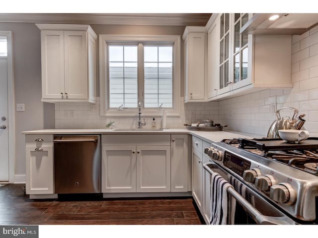 602 D St, Kennett Square, PA 19348 - kitchen with white cabinets, stainless steel appliances, ornamental molding, and a sink