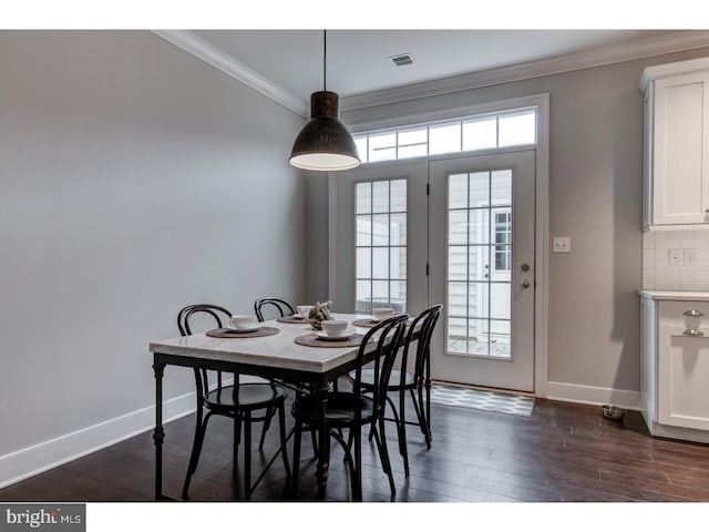 602 D St, Kennett Square, PA 19348 - dining space with baseboards, visible vents, ornamental molding, and dark wood finished floors