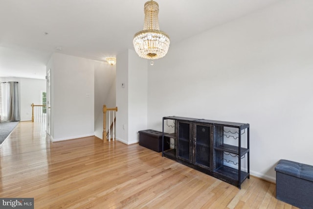 11408 Leland Pl, Waldorf, MD 20601 - empty room with wood finished floors, a chandelier, and baseboards