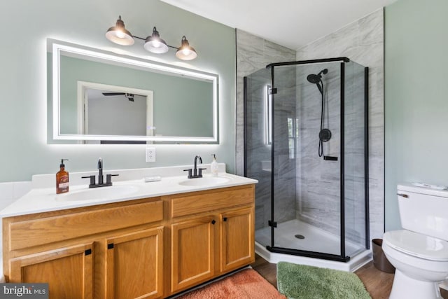 11408 Leland Pl, Waldorf, MD 20601 - bathroom featuring toilet, double vanity, a stall shower, and wood finished floors