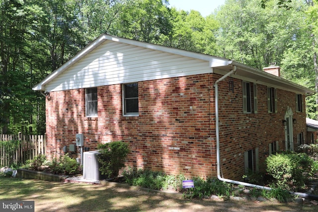 3901 Stoneybrook Rd, White Plains, MD 20695 - view of side of home featuring fence, a chimney, cooling unit, and brick siding