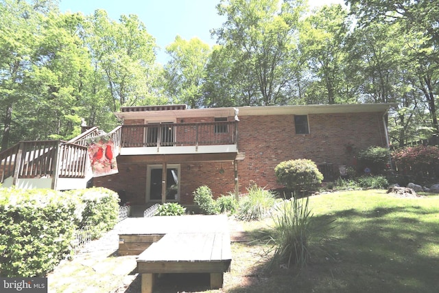 3901 Stoneybrook Rd, White Plains, MD 20695 - rear view of property featuring brick siding, a lawn, and a wooden deck