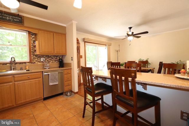 3901 Stoneybrook Rd, White Plains, MD 20695 - kitchen with a sink, a kitchen breakfast bar, a ceiling fan, light tile patterned floors, and stainless steel dishwasher