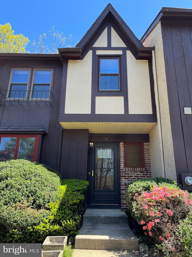 view of exterior entry with board and batten siding