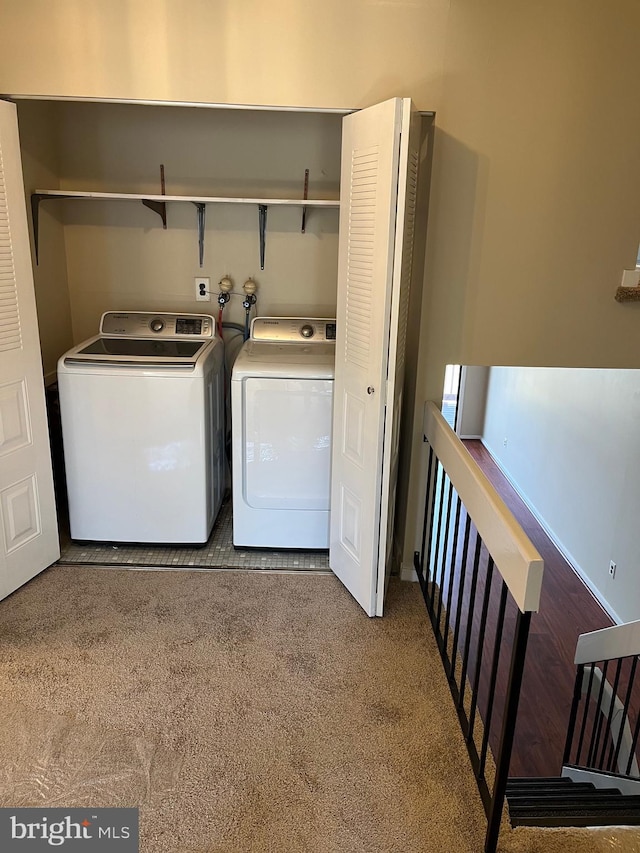 washroom featuring laundry area, washer and clothes dryer, and carpet