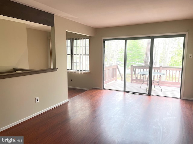 empty room featuring baseboards and wood finished floors