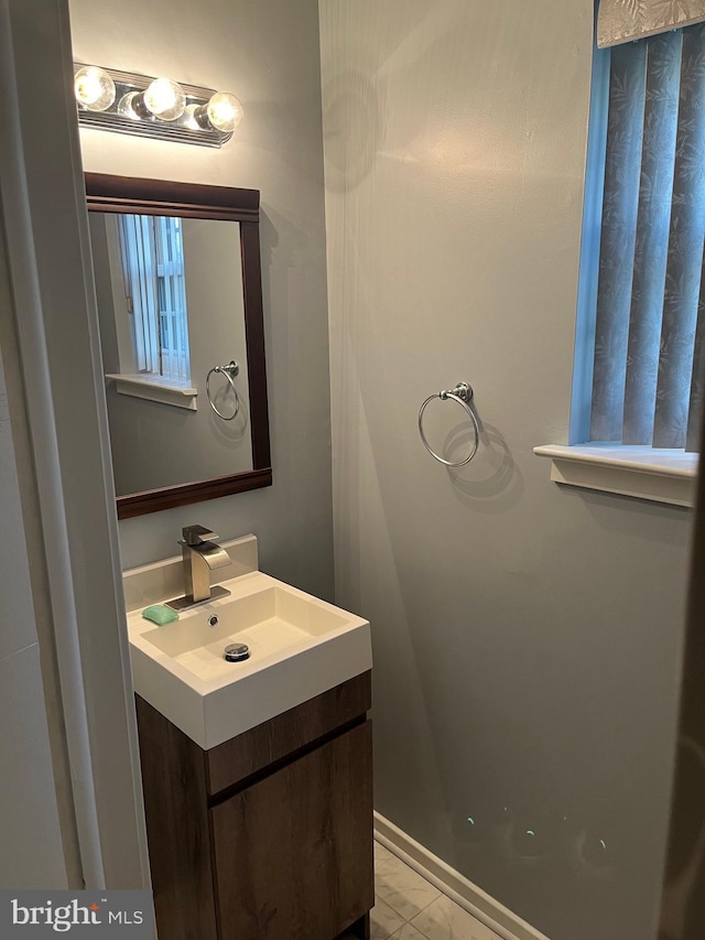 bathroom featuring vanity and marble finish floor