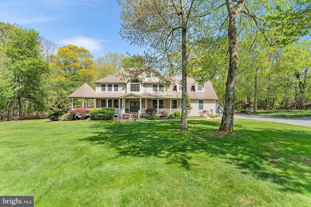 view of front of house with a front yard and a porch