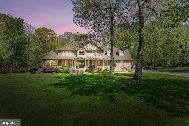 view of front of home featuring covered porch and a front yard