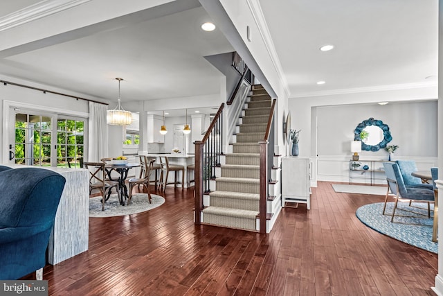 foyer entrance featuring stairway, wood finished floors, a wainscoted wall, recessed lighting, and ornamental molding