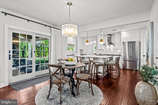 dining room featuring dark wood-style flooring and a chandelier
