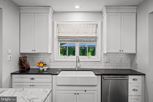 kitchen with stainless steel dishwasher, a sink, decorative backsplash, white cabinetry, and recessed lighting