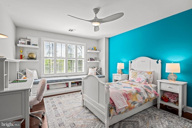 bedroom with wood finished floors, a ceiling fan, and a desk