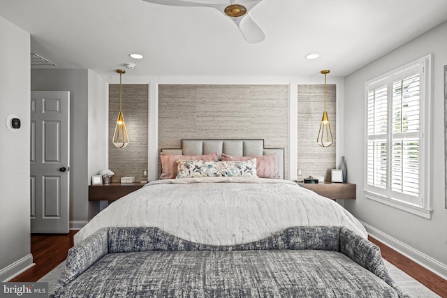 bedroom with baseboards, wood finished floors, and a ceiling fan