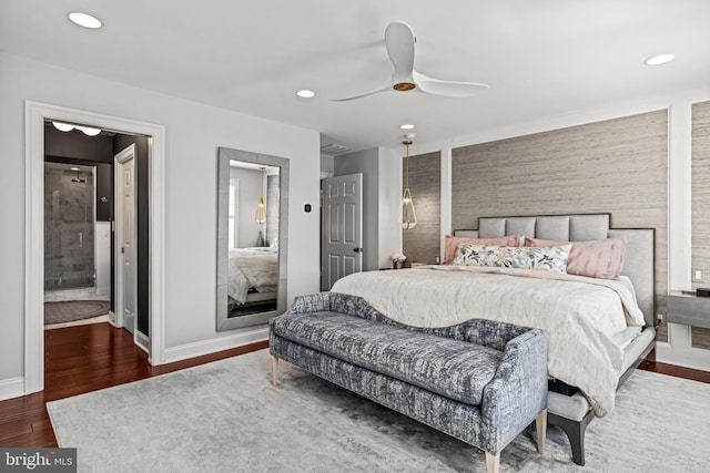 bedroom featuring wood finished floors, baseboards, recessed lighting, a ceiling fan, and ensuite bath