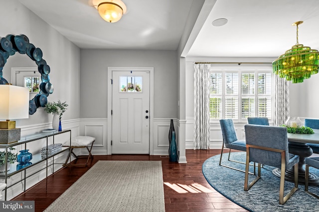 entryway with plenty of natural light, a wainscoted wall, and wood finished floors