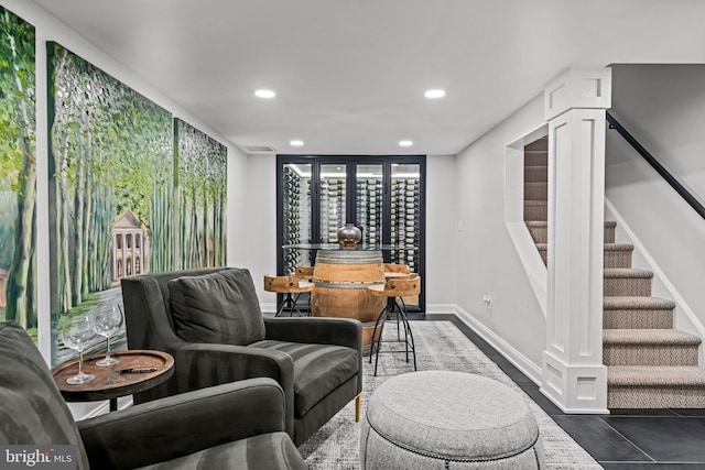 sitting room with recessed lighting, stairs, and baseboards