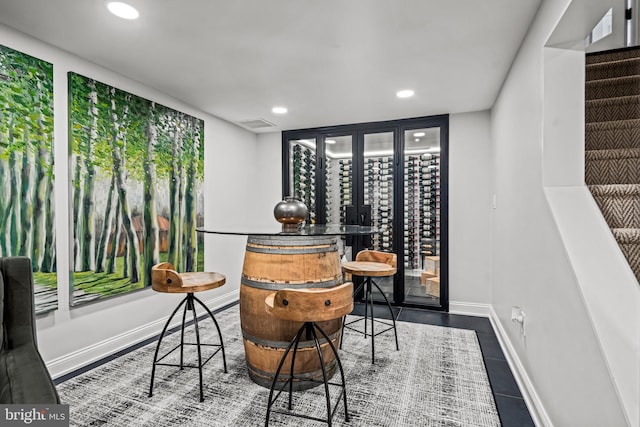 tiled dining area with recessed lighting and baseboards