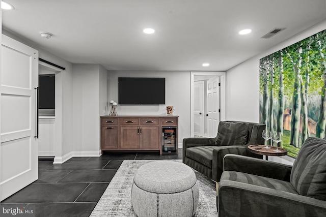 living area featuring recessed lighting, baseboards, and dark tile patterned floors