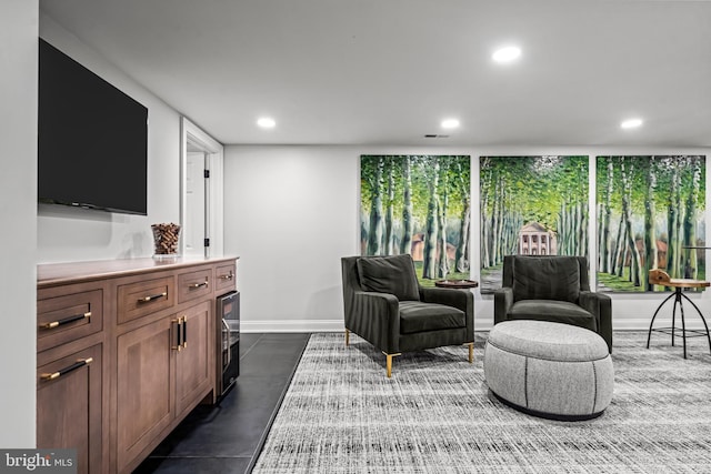 living area with recessed lighting, baseboards, and wine cooler