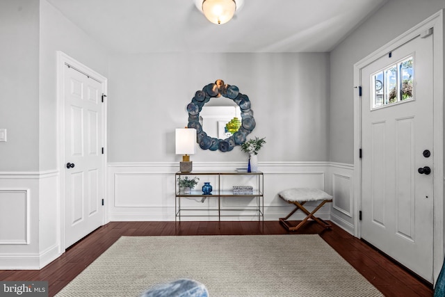foyer with a wainscoted wall and wood finished floors