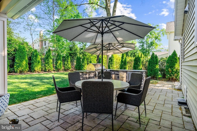 view of patio with area for grilling and outdoor dining area