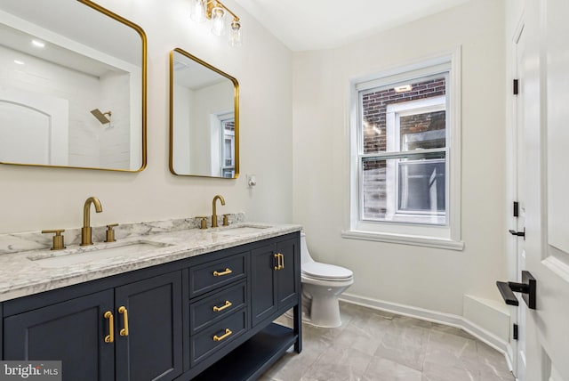 1107 S Divinity St, Philadelphia, PA 19143 - bathroom featuring a sink, baseboards, toilet, and double vanity