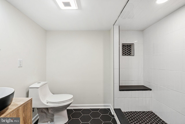 1107 S Divinity St, Philadelphia, PA 19143 - full bathroom featuring vanity, toilet, baseboards, tiled shower, and tile patterned floors