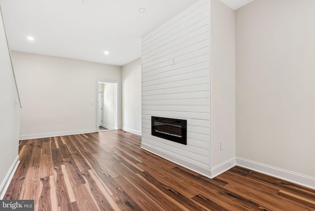 1107 S Divinity St, Philadelphia, PA 19143 - unfurnished living room with baseboards, recessed lighting, a large fireplace, and dark wood-type flooring