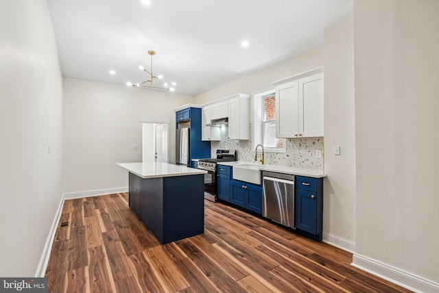 1107 S Divinity St, Philadelphia, PA 19143 - kitchen with dark wood-style flooring, a sink, a center island, stainless steel appliances, and blue cabinets