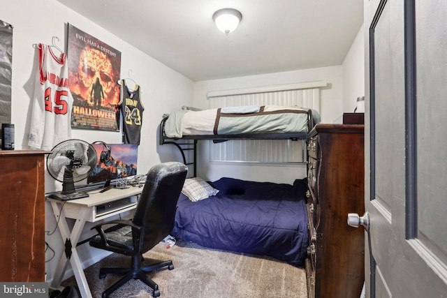 carpeted bedroom featuring a desk