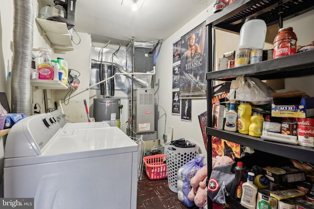 clothes washing area featuring washer and clothes dryer and water heater