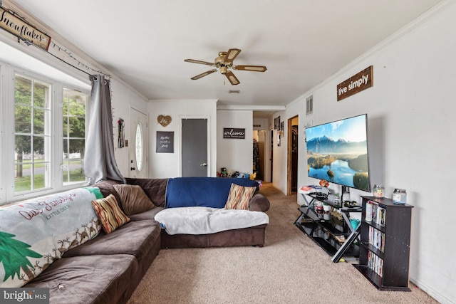 carpeted living area featuring ceiling fan and crown molding