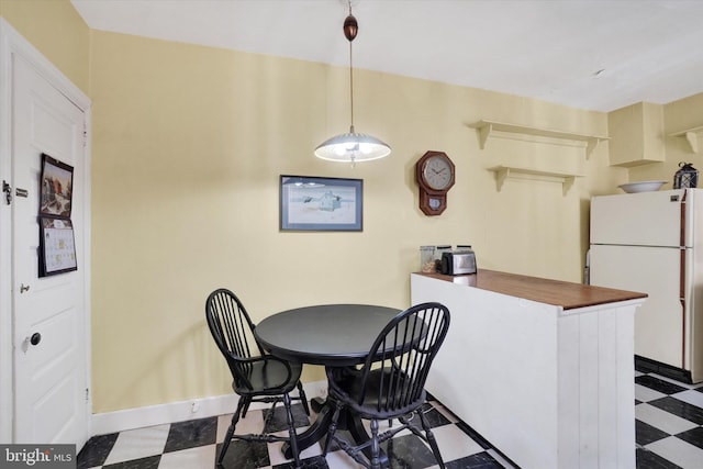 dining space featuring tile patterned floors and baseboards
