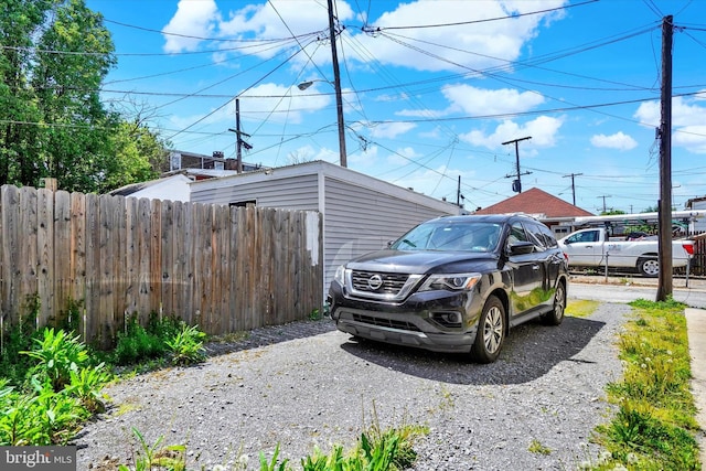view of parking featuring fence