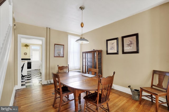 dining room with baseboards and hardwood / wood-style floors
