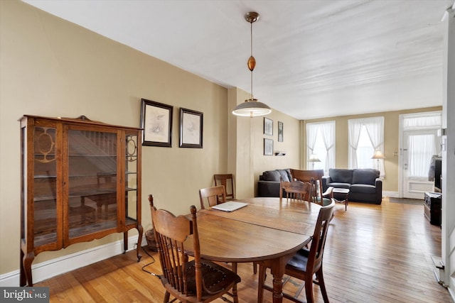 dining room with baseboards and light wood-style flooring